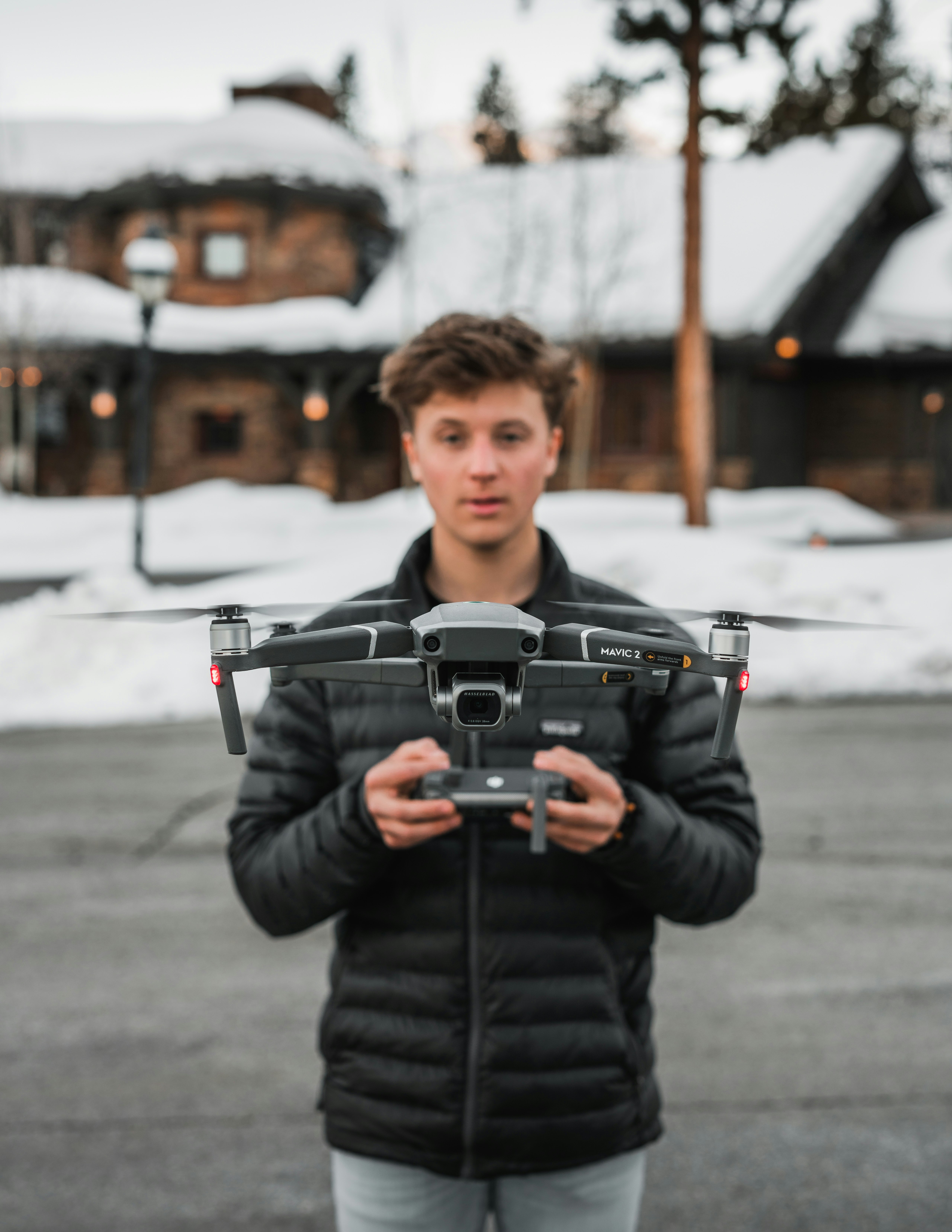 boy in black jacket holding black camera